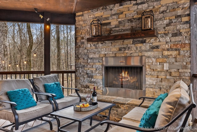 view of patio / terrace with an outdoor living space with a fireplace