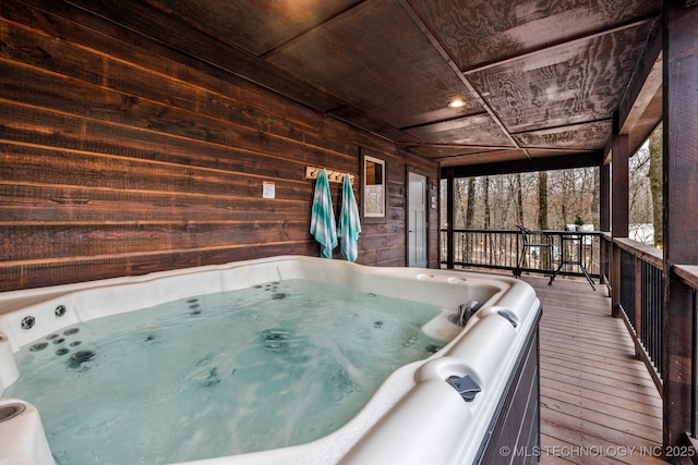 miscellaneous room featuring wooden walls, hardwood / wood-style flooring, wooden ceiling, and a hot tub