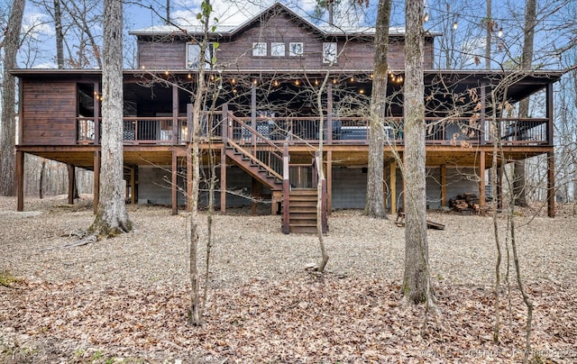 back of house with stairs and a deck