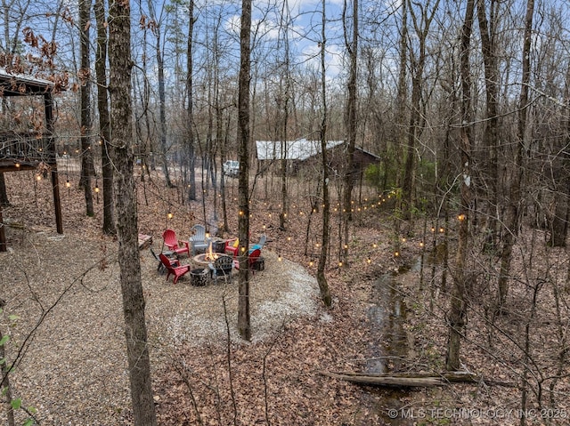 view of yard with an outdoor fire pit