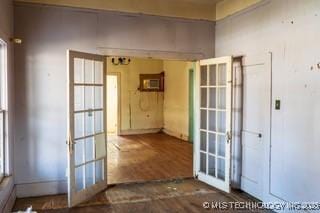 interior space with a wealth of natural light, french doors, and wood finished floors