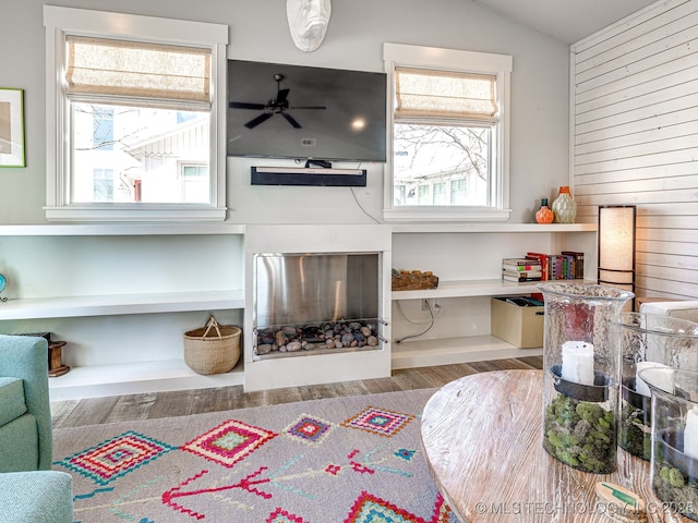 29 Boardwalk Unit F, Carlton Landing, OK 74432 - living area featuring wood walls, wood finished floors, a ceiling fan, vaulted ceiling, and healthy amount of natural light