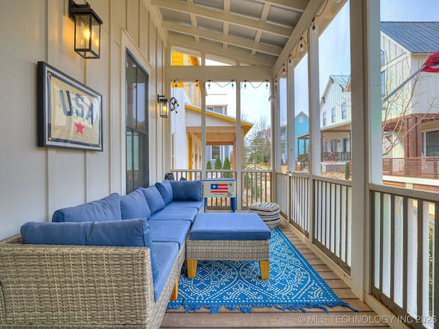sunroom featuring an outdoor living space, plenty of natural light, and vaulted ceiling