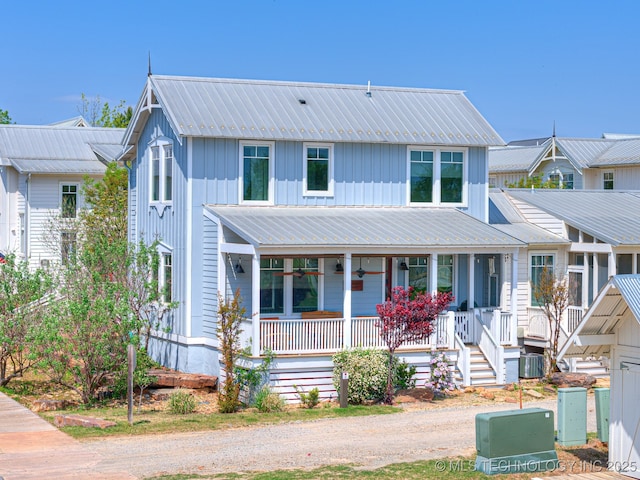 29 Boardwalk Unit F, Carlton Landing, OK 74432 - view of front facade with covered porch, a metal roof, and board and batten siding