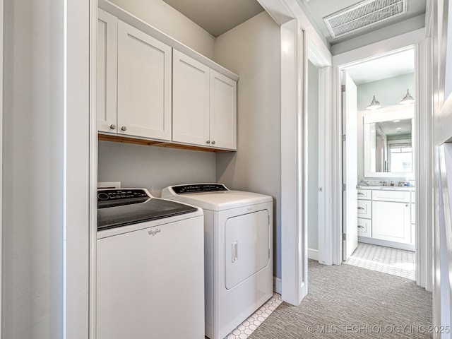 29 Boardwalk Unit F, Carlton Landing, OK 74432 - washroom featuring cabinet space, washing machine and clothes dryer, and light carpet