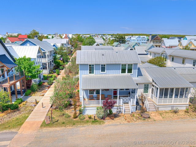 29 Boardwalk Unit F, Carlton Landing, OK 74432 - view of front of house with a residential view, a sunroom, a metal roof, and covered porch