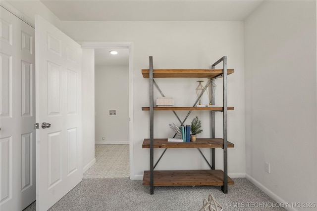 corridor with carpet flooring and baseboards