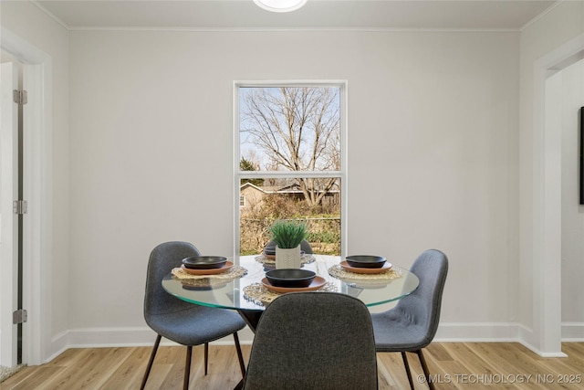 dining area with a healthy amount of sunlight, baseboards, and wood finished floors