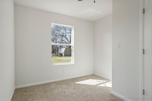 carpeted spare room with baseboards