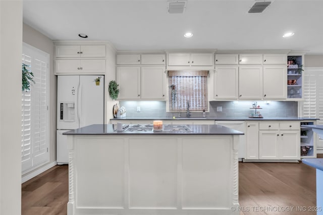 kitchen with gas cooktop, visible vents, open shelves, a sink, and white fridge with ice dispenser