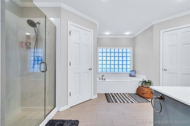 bathroom featuring a garden tub, ornamental molding, a shower stall, and tile patterned flooring