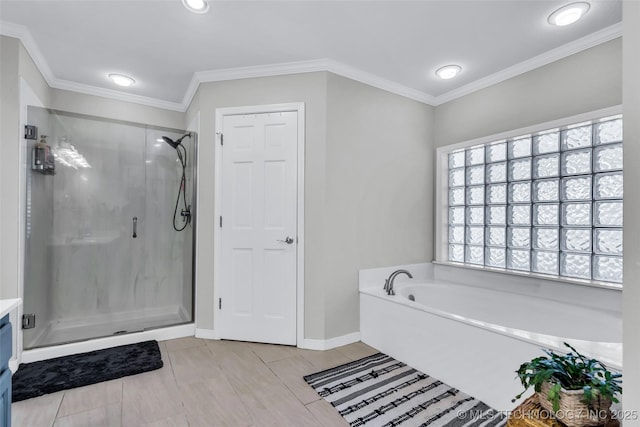 full bathroom with baseboards, a garden tub, a shower stall, and crown molding