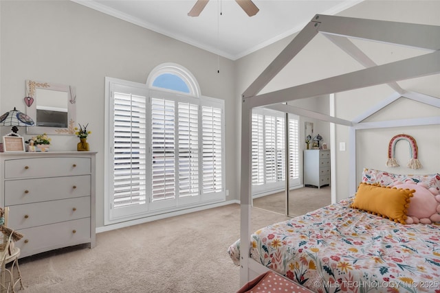 bedroom with lofted ceiling, ceiling fan, carpet flooring, and crown molding