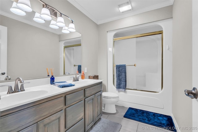 bathroom featuring tile patterned flooring, toilet, crown molding, and a sink