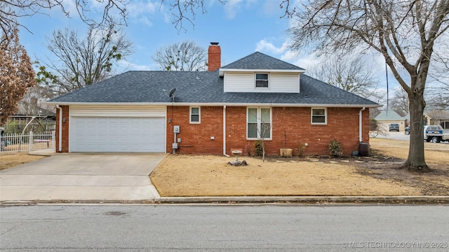 view of front of property featuring a shingled roof, fence, brick siding, and a chimney