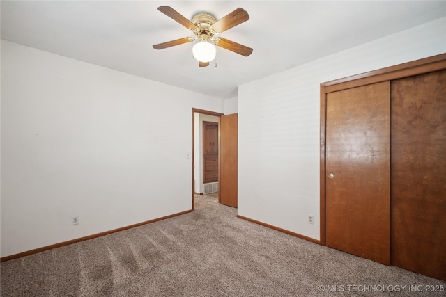 unfurnished bedroom with a closet, ceiling fan, baseboards, and carpet