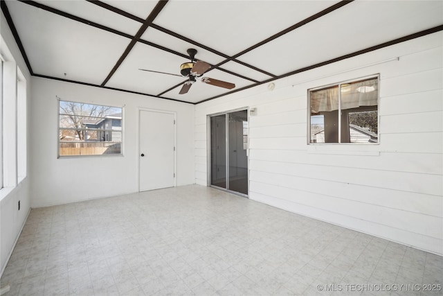 empty room featuring tile patterned floors and a ceiling fan