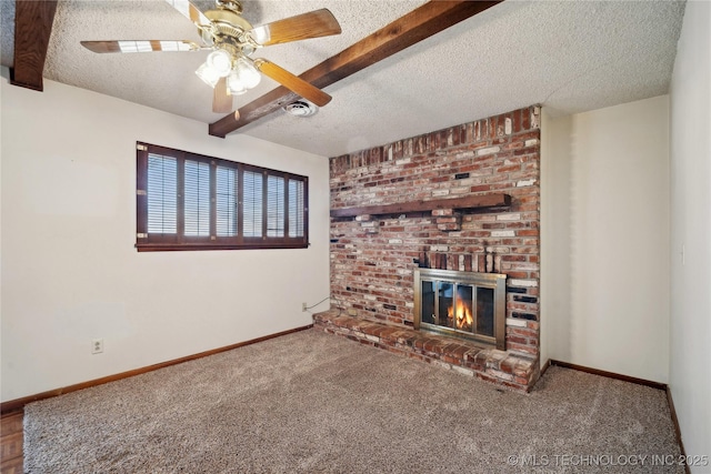 unfurnished living room featuring carpet flooring, baseboards, a textured ceiling, and a fireplace