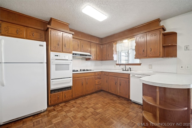 kitchen featuring white appliances, open shelves, extractor fan, light countertops, and a warming drawer