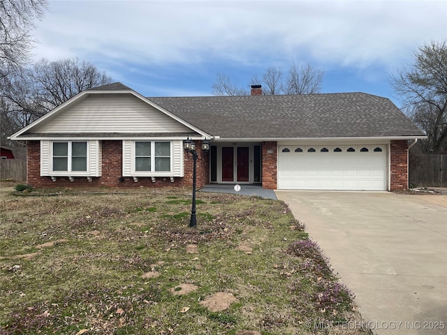 ranch-style home featuring a chimney, a shingled roof, concrete driveway, a garage, and brick siding