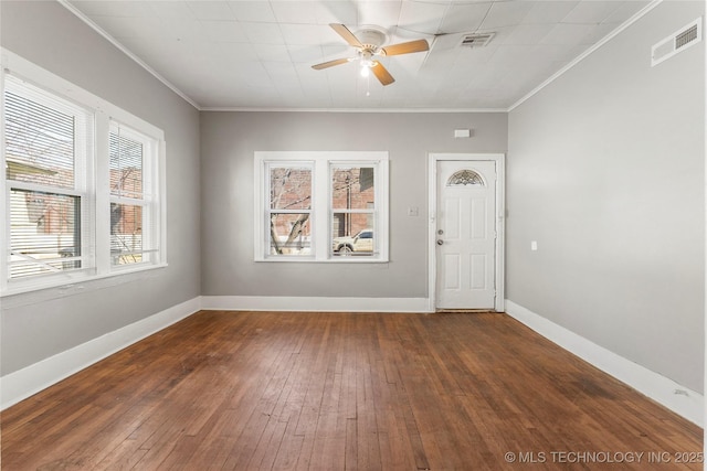 spare room featuring a ceiling fan, baseboards, visible vents, and ornamental molding