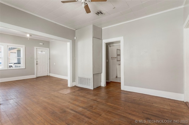 spare room with visible vents, baseboards, ceiling fan, and hardwood / wood-style flooring