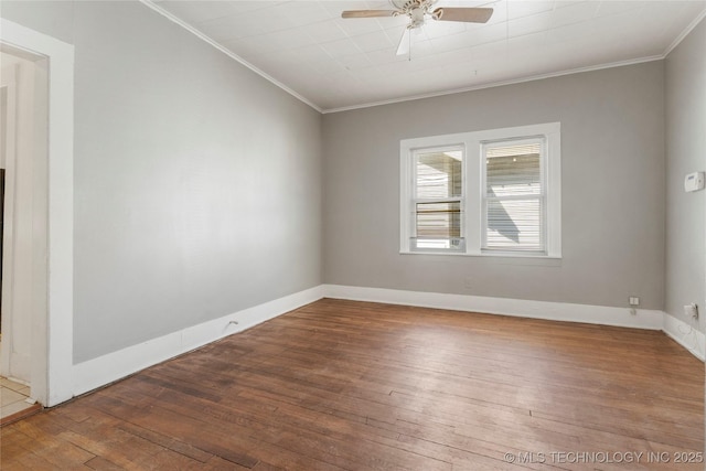 spare room featuring ornamental molding, baseboards, a ceiling fan, and hardwood / wood-style flooring