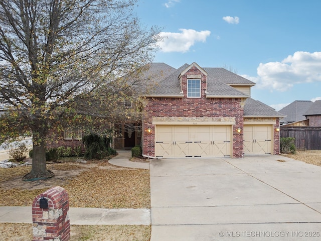 view of front facade with fence, driveway, roof with shingles, a garage, and brick siding