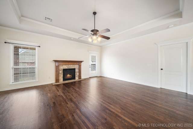 unfurnished living room featuring ceiling fan, a raised ceiling, visible vents, and dark wood-type flooring