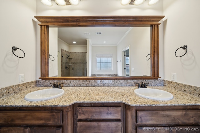 full bathroom featuring a sink, double vanity, a shower stall, and crown molding