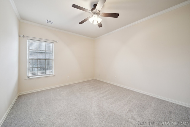 spare room with visible vents, a ceiling fan, carpet flooring, crown molding, and baseboards