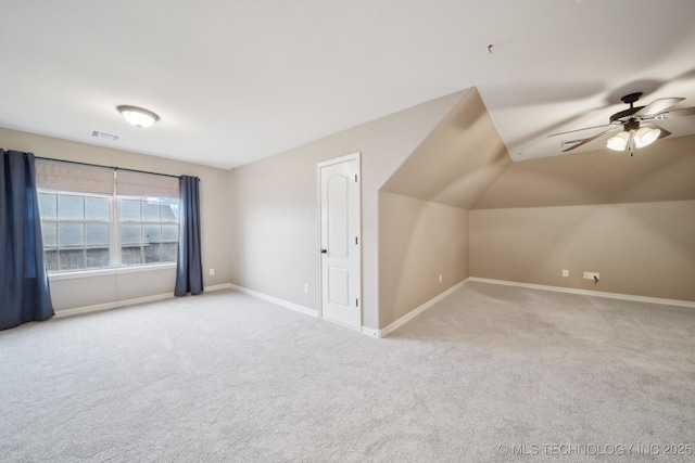 additional living space featuring visible vents, ceiling fan, baseboards, carpet, and lofted ceiling