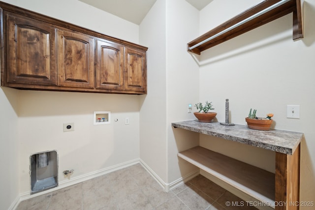 clothes washing area with baseboards, gas dryer hookup, washer hookup, cabinet space, and electric dryer hookup