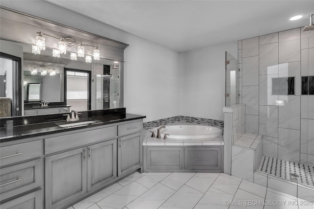 bathroom featuring a shower stall, a garden tub, a notable chandelier, marble finish floor, and vanity