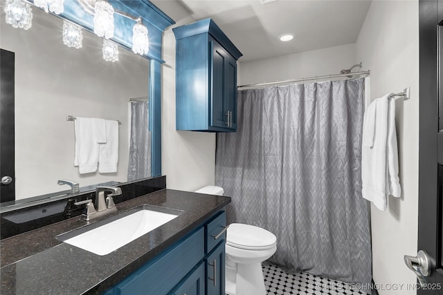 bathroom with toilet, vanity, and a shower with curtain