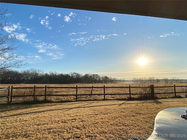 view of yard featuring a rural view and fence