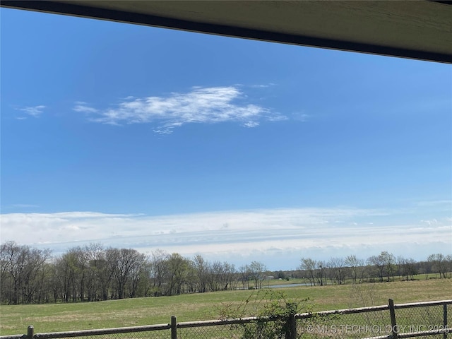 view of yard with a rural view and fence