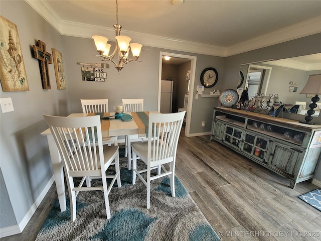 dining area with baseboards, a notable chandelier, wood finished floors, and ornamental molding