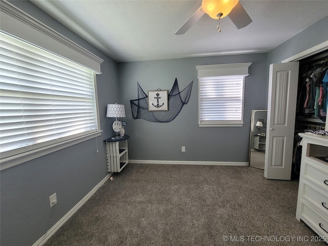 carpeted bedroom featuring multiple windows, a ceiling fan, baseboards, and a textured ceiling