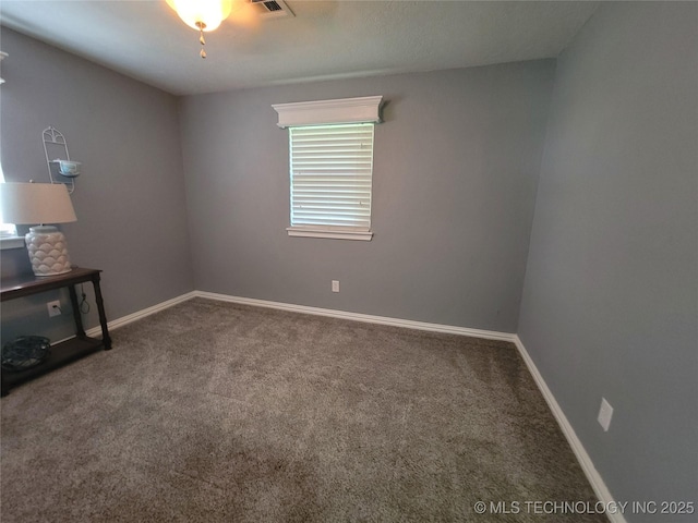 carpeted empty room featuring visible vents and baseboards