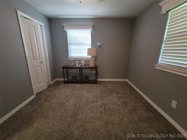 empty room with carpet flooring and baseboards