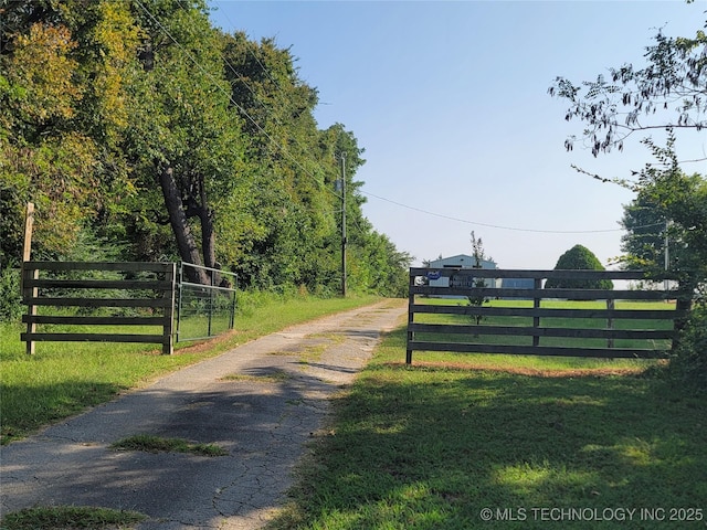 view of road with a gate and driveway