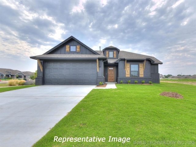 view of front facade with a front yard, a garage, driveway, and roof with shingles