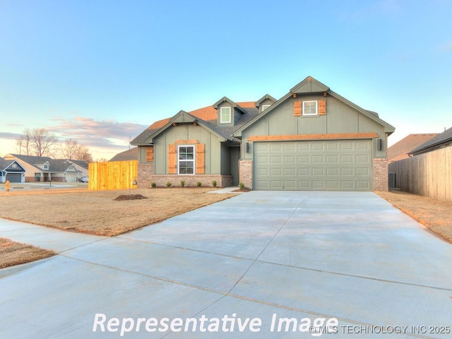 view of front of home with fence, brick siding, and driveway