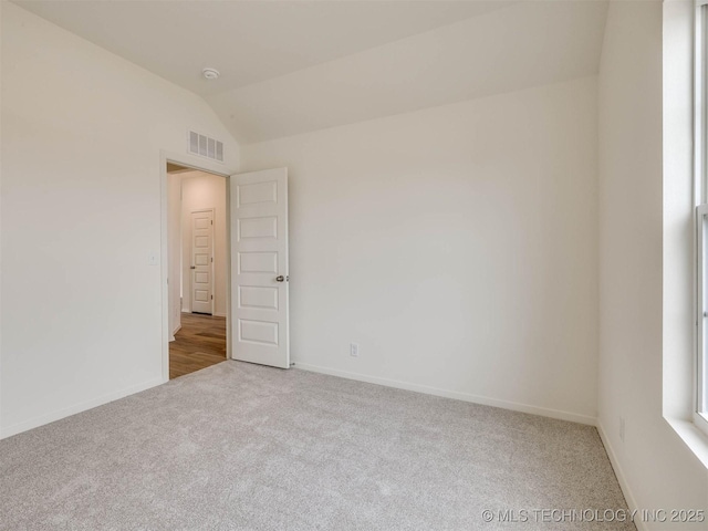 13404 E 123rd Pl, Collinsville, OK 74021 - spare room featuring baseboards, lofted ceiling, visible vents, and carpet