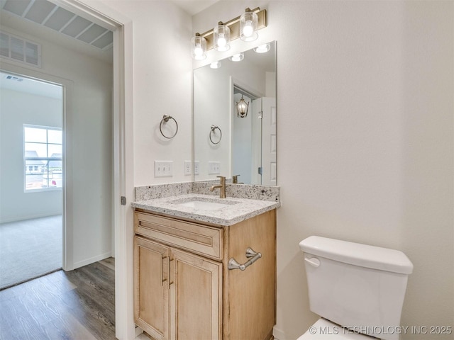 13404 E 123rd Pl, Collinsville, OK 74021 - bathroom with wood finished floors, visible vents, toilet, and vanity