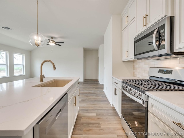 13404 E 123rd Pl, Collinsville, OK 74021 - kitchen with stainless steel appliances, visible vents, a sink, a center island with sink, and tasteful backsplash