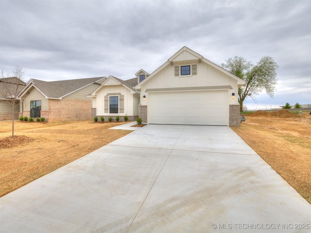13404 E 123rd Pl, Collinsville, OK 74021 - view of front of home featuring a garage, brick siding, board and batten siding, and concrete driveway
