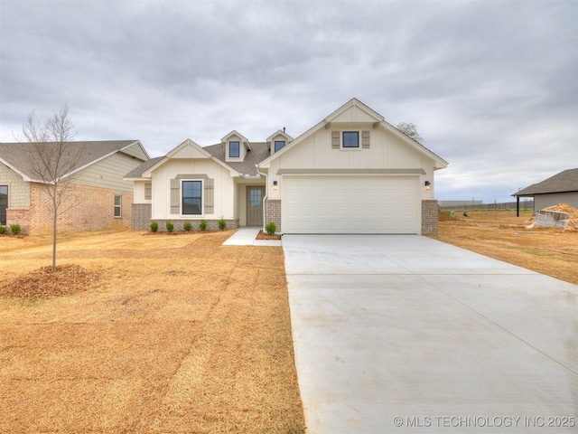 13404 E 123rd Pl, Collinsville, OK 74021 - view of front of house featuring a garage, brick siding, board and batten siding, and concrete driveway