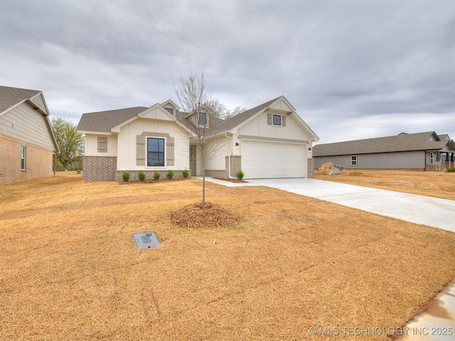 13404 E 123rd Pl, Collinsville, OK 74021 - view of front of home featuring board and batten siding, brick siding, a front lawn, and driveway